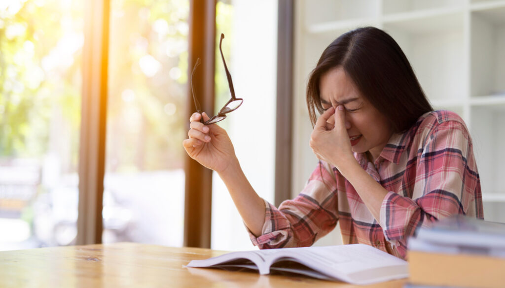 Asian,Girl,Reading,A,Book,Eye,Pain,,Stress,