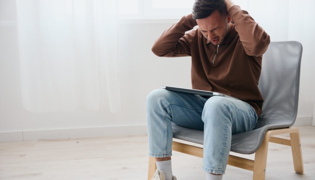 Suffering,Irritated,Crying,Young,Man,Feels,Pain,In,Back,Of